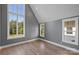 Sunlit bedroom with hardwood floors and large windows offering scenic backyard views at 5022 Ohm Ln, Charlotte, NC 28270