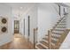 Hallway and staircase featuring wood floors and stairs, and a decorative light fixture at 5022 Ohm Ln, Charlotte, NC 28270