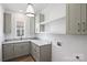 Well-organized laundry room features gray cabinets, marble countertops, and ample storage at 5022 Ohm Ln, Charlotte, NC 28270