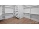 Bright walk-in closet with custom shelving and hanging rods offer ample storage at 5022 Ohm Ln, Charlotte, NC 28270