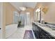 Spa-like bathroom with soaking tub, marble floors, and walk-in shower at 5523 Closeburn Rd, Charlotte, NC 28210