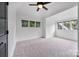 Bright bedroom with carpeted floor, ceiling fan, and multiple windows at 5523 Closeburn Rd, Charlotte, NC 28210