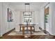 Bright dining room featuring a wood table, white chairs, and stylish light fixture at 5523 Closeburn Rd, Charlotte, NC 28210