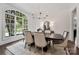 Formal dining room with a dark wood table, neutral chairs, and an arched window at 5523 Closeburn Rd, Charlotte, NC 28210