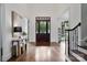 Elegant entryway with hardwood floors, a dark wood door, and a console table at 5523 Closeburn Rd, Charlotte, NC 28210