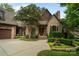 Brick home with three-car garage and a welcoming front entrance at 5523 Closeburn Rd, Charlotte, NC 28210