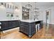 Modern kitchen featuring a large island, dark cabinetry, and marble countertops at 5523 Closeburn Rd, Charlotte, NC 28210