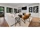 Open living room with built-in shelving, fireplace, and French doors at 5523 Closeburn Rd, Charlotte, NC 28210