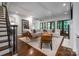 Spacious living room with hardwood floors, white sectional sofa, and fireplace at 5523 Closeburn Rd, Charlotte, NC 28210