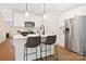 Modern kitchen with white cabinets, stainless steel appliances, and an island at 734 Cantwell St, Charlotte, NC 28208