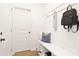 Functional mudroom with built-in bench, hooks, and white beadboard paneling at 734 Cantwell St, Charlotte, NC 28208