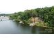 Lakefront home with private boat docks, surrounded by lush trees and tranquil water at 152 Bridge Pointe Ln, Hickory, NC 28601
