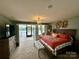 Comfortable bedroom featuring access to a deck overlooking the lake at 152 Bridge Pointe Ln, Hickory, NC 28601