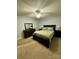 A cozy bedroom featuring neutral walls and carpet, a ceiling fan, and dark wooden bedroom furniture at 152 Bridge Pointe Ln, Hickory, NC 28601