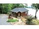 Charming cedar home with stone pathway, mature landscaping, and serene lake views at 152 Bridge Pointe Ln, Hickory, NC 28601