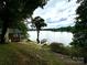 A scenic view of a home with a lake and a private dock, surrounded by lush greenery and a beautiful landscape at 152 Bridge Pointe Ln, Hickory, NC 28601