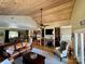 Bright living room featuring hardwood floors, a wood-paneled ceiling, and a cozy fireplace at 152 Bridge Pointe Ln, Hickory, NC 28601