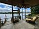 Enjoy lake views from this screened porch with a ceiling fan and comfortable seating at 152 Bridge Pointe Ln, Hickory, NC 28601