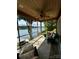 Enclosed sunroom with outdoor furniture, ceiling fan, and beautiful lake view at 152 Bridge Pointe Ln, Hickory, NC 28601