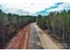 Aerial view of the construction of a paved road through the woods at 1021 Baylor Grv, Monroe, NC 28110