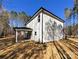 The rear exterior of the home showcasing a covered patio, offering a perfect blend of indoor/outdoor living at 1021 Baylor Grv, Monroe, NC 28110