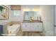 Bathroom showcasing double vanity, granite countertops, bathtub, and tiled floors at 133 Sari St, Troutman, NC 28166