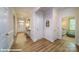 Bright hallway featuring hardwood floors, clean white walls, and stylish decor at 133 Sari St, Troutman, NC 28166