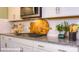 Close-up of a kitchen counter featuring granite countertops and subway tile backsplash at 133 Sari St, Troutman, NC 28166