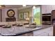 Kitchen with granite island, stainless steel appliances, and seamless flow to the living room at 133 Sari St, Troutman, NC 28166