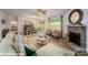 Open-concept living room with a stone fireplace, dining area, and large windows for natural light at 133 Sari St, Troutman, NC 28166