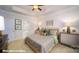 Bright main bedroom features a decorative tray ceiling, furnishings, and a glimpse of the ensuite bath at 133 Sari St, Troutman, NC 28166