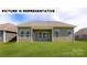 Expansive backyard with green lawn and view of the home's rear exterior at 145 Sari St, Troutman, NC 28166