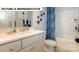 Well-lit bathroom featuring a vanity with white cabinets, a shower-tub combination, and modern fixtures at 145 Sari St, Troutman, NC 28166