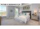 Bright bedroom featuring large windows, stylish curtains, and a comfortable bed with decorative pillows at 145 Sari St, Troutman, NC 28166