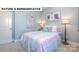 Bright, cheerful bedroom with a colorful bed, soft carpet, and a view of the outdoors at 145 Sari St, Troutman, NC 28166