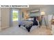 Comfortable bedroom features a queen-size bed, soft carpet, and a large window with natural light at 145 Sari St, Troutman, NC 28166