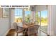 Cozy dining area with a round table, wicker chairs, and natural light from the windows at 145 Sari St, Troutman, NC 28166