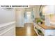Inviting hallway with hardwood floors, elegant wainscoting, and a decorative console table at 145 Sari St, Troutman, NC 28166