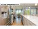 Bright, open kitchen with stainless steel appliances, island seating, and hardwood floors at 145 Sari St, Troutman, NC 28166