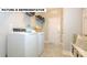 Functional laundry room with a washer, dryer, shelving, and ample storage space at 145 Sari St, Troutman, NC 28166