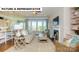 Open-concept living room boasts large windows, a fireplace, comfortable seating, and seamless flow to the kitchen at 145 Sari St, Troutman, NC 28166
