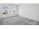 Cozy bedroom featuring two windows with neighborhood views and carpeted floors at 2140 Indigo Branch Rd, Indian Land, SC 29707