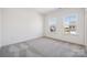 Bright bedroom features two windows and neutral carpet, ready for personalization at 2140 Indigo Branch Rd, Indian Land, SC 29707