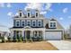 Charming two-story home with a blue exterior, well-manicured landscaping, and a two-car garage at 2140 Indigo Branch Rd, Indian Land, SC 29707