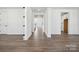 Bright hallway featuring hardwood floors, white trim, and an open-concept design at 2140 Indigo Branch Rd, Indian Land, SC 29707