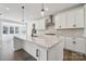 Modern kitchen features white cabinets, stainless steel appliances, an island, and hardwood floors at 2140 Indigo Branch Rd, Indian Land, SC 29707
