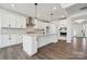 Bright kitchen with white cabinets, a large island, stainless steel appliances, and hardwood floors at 2140 Indigo Branch Rd, Indian Land, SC 29707