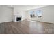 Spacious living room with a fireplace, hardwood floors, and large windows providing natural light at 2140 Indigo Branch Rd, Indian Land, SC 29707