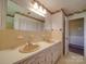 Double sink bathroom with sunflower wallpaper and beige tile at 2406 Faulks Church Rd, Wingate, NC 28174