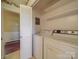 Convenient laundry room with washer, dryer, and built-in shelving at 2406 Faulks Church Rd, Wingate, NC 28174